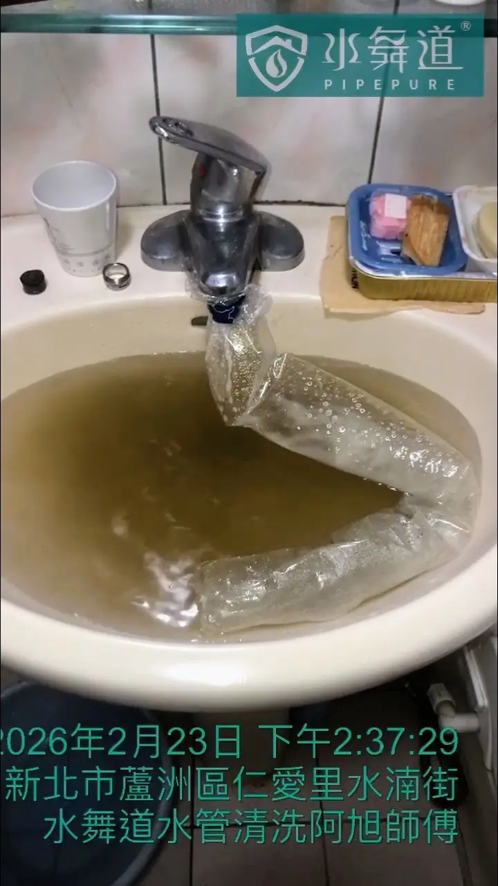 水管清洗中段，浴室洗手台的水色轉為更深的橘紅色，顯示管線深層的鐵鏽與沉積物被帶出。